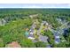 An aerial view showcases houses with manicured lawns surrounded by lush trees at 180 Willowbend Ln, Summerville, SC 29485