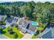 Aerial shot of a property features a pool, landscaping, and a manicured lawn at 180 Willowbend Ln, Summerville, SC 29485