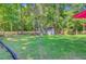 The backyard features a shed, a lush lawn, and a charming windmill decoration at 180 Willowbend Ln, Summerville, SC 29485