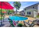 Backyard pool with seating, greenery, and lounge chairs creating a relaxing outdoor space at 180 Willowbend Ln, Summerville, SC 29485