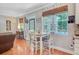 Cozy dining area with a view of the pool, hardwood floors, and a stylish table set for four at 180 Willowbend Ln, Summerville, SC 29485