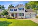 Charming two-story home featuring a well-manicured lawn, a two-car garage, and a lovely front garden at 180 Willowbend Ln, Summerville, SC 29485