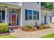 Inviting home entrance with a decorative red door and well-maintained landscaping and a water fountain at 180 Willowbend Ln, Summerville, SC 29485
