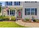 Inviting front porch with an American flag, a welcome sign, and a beautifully landscaped garden area at 180 Willowbend Ln, Summerville, SC 29485