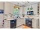 Modern kitchen with white cabinets, a stone tile backsplash, and stainless steel appliances for a sleek design at 180 Willowbend Ln, Summerville, SC 29485