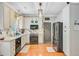 Well-lit kitchen featuring granite countertops, stainless steel appliances, and a stylish tile backsplash at 180 Willowbend Ln, Summerville, SC 29485