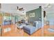 Spacious living room with hardwood floors, a cozy sectional, and lots of natural light from multiple windows at 180 Willowbend Ln, Summerville, SC 29485
