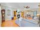 Comfortable living room with a fireplace, hardwood floors, and a large sectional for relaxing and watching TV at 180 Willowbend Ln, Summerville, SC 29485