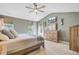 Bright main bedroom featuring a ceiling fan, TV, dresser, and plenty of natural light at 180 Willowbend Ln, Summerville, SC 29485