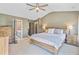 Primary bedroom featuring king-size bed, natural light, and adjoining bathroom at 180 Willowbend Ln, Summerville, SC 29485