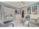 Outdoor sunroom featuring tile floors, natural light, and relaxing gray decor at 180 Willowbend Ln, Summerville, SC 29485