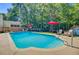 Beautiful swimming pool with lounge chairs and umbrellas, set in a private backyard oasis at 180 Willowbend Ln, Summerville, SC 29485