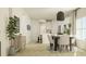 Open-concept dining area features stylish decor, wood floors, a modern light fixture, and easy access to the kitchen at 189 Norse Bay, Summerville, SC 29486