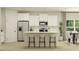 Bright kitchen showcasing a large island with seating, white cabinets, stainless steel appliances and modern finishes at 189 Norse Bay, Summerville, SC 29486
