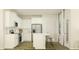 Modern kitchen with white cabinets, stainless steel appliances, and a functional center island at 190 Norse Bay, Summerville, SC 29486