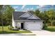 Charming single-story home with a light gray exterior, attached garage, and well-manicured lawn at 192 Norse Bay, Summerville, SC 29486