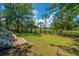 Expansive backyard with a patio, lush lawn, and beautiful waterfront views beyond the fence at 1971 N North Creek Dr, Mount Pleasant, SC 29466