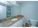 Bathroom with granite vanity, faucet, mirror, patterned shower curtain, toilet and neutral color paint at 1971 N North Creek Dr, Mount Pleasant, SC 29466