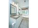 Bright bathroom features a double vanity, soaking tub, and a large window with serene views at 1971 N North Creek Dr, Mount Pleasant, SC 29466