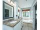 Elegant bathroom with double vanity, soaking tub, and ample natural light from a large window at 1971 N North Creek Dr, Mount Pleasant, SC 29466