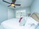 Well-lit bedroom with a ceiling fan, a comfy bed with decorative pillows, carpet, and window with blinds at 1971 N North Creek Dr, Mount Pleasant, SC 29466