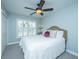 Bright bedroom features a comfortable bed, soft carpet, natural light from the window and a ceiling fan at 1971 N North Creek Dr, Mount Pleasant, SC 29466