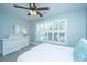 Bright bedroom with a ceiling fan, a bed with a patterned pillow, window with blinds and dresser with vanity mirror at 1971 N North Creek Dr, Mount Pleasant, SC 29466