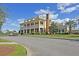 Rivertowne Country Club boasts a stately clubhouse with a grand entrance and manicured landscaping at 1971 N North Creek Dr, Mount Pleasant, SC 29466