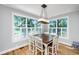 Bright dining space with large windows, hardwood floors and traditional chandelier lighting at 1971 N North Creek Dr, Mount Pleasant, SC 29466