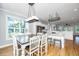 Bright dining space with large windows, hardwood floors adjoins the kitchen with stainless appliances at 1971 N North Creek Dr, Mount Pleasant, SC 29466