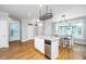Bright dining area with wood floors, an island with seating, and ample natural light at 1971 N North Creek Dr, Mount Pleasant, SC 29466