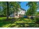 Picturesque backyard with a view of a charming home, lush greenery, and a tranquil waterfront at 1971 N North Creek Dr, Mount Pleasant, SC 29466