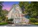 Charming two-story home with a white exterior, lovely front yard, and inviting stairway to the front porch at 1971 N North Creek Dr, Mount Pleasant, SC 29466