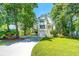 Beautifully landscaped home exterior with manicured lawn, a spacious driveway, and inviting front entrance at 1971 N North Creek Dr, Mount Pleasant, SC 29466