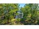 Charming two-story home with dual balconies, lush landscaping, mature trees, and fenced backyard at 1971 N North Creek Dr, Mount Pleasant, SC 29466