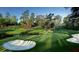 Manicured golf course fairway with sand traps and water hazard on a sunny day at 1971 N North Creek Dr, Mount Pleasant, SC 29466
