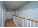 Bright hallway with board and batten accent wall and hardwood floors leading to the stairway at 1971 N North Creek Dr, Mount Pleasant, SC 29466
