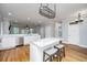 Gourmet kitchen featuring stainless steel appliances, white cabinets, an island with marble countertop and hardwood floors at 1971 N North Creek Dr, Mount Pleasant, SC 29466