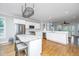 Open kitchen featuring white cabinets, stainless steel appliances, an island with marble countertop and hardwood floors at 1971 N North Creek Dr, Mount Pleasant, SC 29466