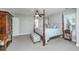 Spacious main bedroom featuring four-poster bed, private bathroom, and ample natural light at 1971 N North Creek Dr, Mount Pleasant, SC 29466