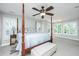 Bright main bedroom with four poster bed, ceiling fan and large windows at 1971 N North Creek Dr, Mount Pleasant, SC 29466