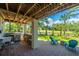 Inviting outdoor kitchen and patio area with stainless steel grill, bar, and a cozy seating area at 1971 N North Creek Dr, Mount Pleasant, SC 29466