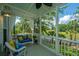 Screened porch with wicker furniture, blue cushions, and picturesque waterfront views at 1971 N North Creek Dr, Mount Pleasant, SC 29466