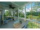 Relaxing screened porch with comfortable seating, ceiling fan, and scenic views of the waterfront at 1971 N North Creek Dr, Mount Pleasant, SC 29466
