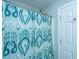Close-up view of a bathroom with a teal patterned shower curtain and white door at 1971 N North Creek Dr, Mount Pleasant, SC 29466