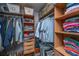 Organized closet with hanging storage and wooden shelves to store folded clothes at 1971 N North Creek Dr, Mount Pleasant, SC 29466