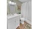 Well-lit bathroom featuring a tiled mirror, white vanity, and shower with a white shower curtain at 2011 N Highway 17 # 1900G, Mount Pleasant, SC 29466