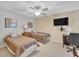 Bright bedroom featuring neutral carpet, ceiling fan, two beds, artwork, and a wall-mounted television at 2011 N Highway 17 # 1900G, Mount Pleasant, SC 29466