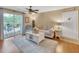 Comfortable living room with a ceiling fan, a sliding door to a balcony, and neutral decor at 2011 N Highway 17 # 1900G, Mount Pleasant, SC 29466