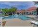 Community pool surrounded by lounge chairs and lush landscaping with a clubhouse in the background at 2011 N Highway 17 # 1900G, Mount Pleasant, SC 29466